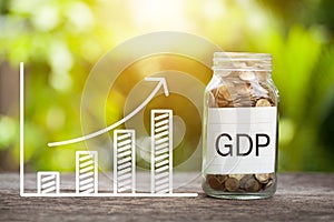 GDP Word With Coin In Glass Jar and graph up. Financial Concept.