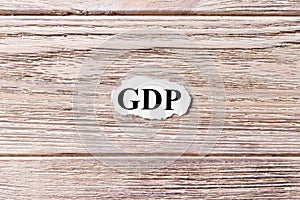 GDP of the word on paper. Gross Domestic Product concept. Words of GDP on a wooden background