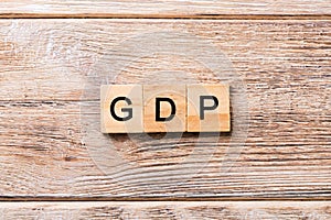GDP word written on wood block. GDP text on wooden table for your desing, concept
