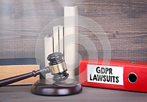 GDPR and lawsuits. Wooden gavel and books in background