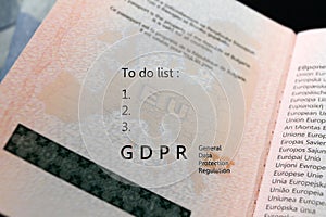 GDPR regulation text General Data Protection Regulation and To do list text on a map of European union EU on a passport, with