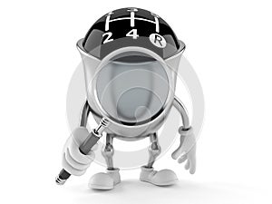 Gear knob character looking through magnifying glass