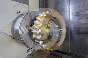 Gear processing on a CNC machine made of bronze, close-up gear cutting production