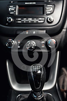 Gear shift in the car and central console in the background