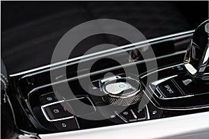 Gear shift controller in new luxurious car interior near automatic gearbox handle close up view.