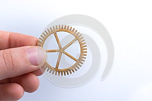 Gear wheel in hand on white background as concept of engineering