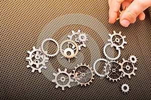 Gear wheel in hand on white background as concept of engineering