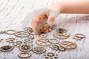 Gear wheel in hand on white background as concept of engineering