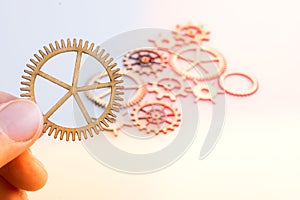 Gear wheel in hand on white background as concept of engineering