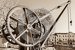 Gear wheels of an old and vintage crane, on lake Maggiore, Italy