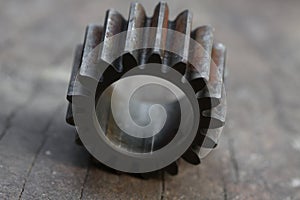 Gear on wooden background, Machine parts or spare parts, industry background, old gear or damaged gear from hard work