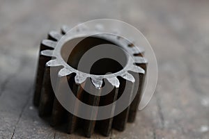 Gear on wooden background, Machine parts or spare parts, industry background, old gear or damaged gear from hard work