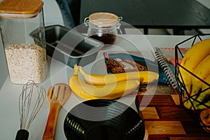 Gearing up for baking success: Fresh banana, pot, and cookbook in frame