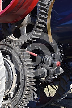 The gears belong of a steering mechanism are part of a refurbished steam power tractor or steam engine