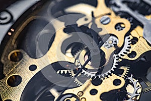 Gears and cogs inside clock. Close-up view on retro watches.
