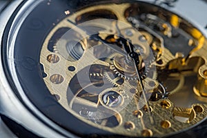 Gears and cogs inside clock. Close-up view on retro watches.