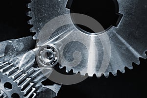 Gears and cogwheels set against black background