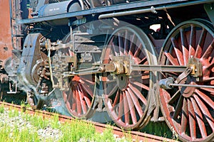 Gears and driving wheels of an old steam train locomotive photo