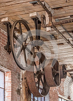 Gears and pulleys on a ceiling in old warehouse