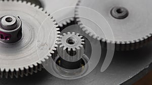 Gears rotating in a mechanical device. Machine metal gears rotating abstract