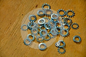 Gears and Washers on Wooden Background