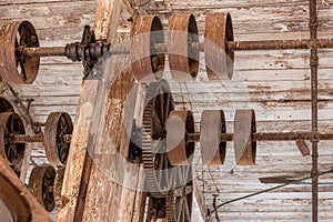 Gears and wheels on ceiling in old warehouse