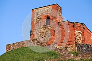 Gediminas' Tower in Vilnius, a part of the back castle part on green hill and blue sky