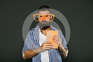 Geek is chic. Study nerd holding book. University male student with lecture notes. Book nerd wearing fancy glasses