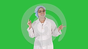 Geek young blonde doctor woman talking to camera on a Green Screen, Chroma Key.