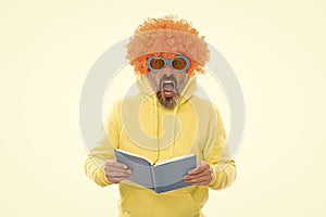 Geeky bibliophile in funky wig keep mouth open reading school book, library