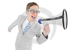 Geeky businessman shouting through megaphone