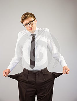 Geeky businessman showing his empty pockets
