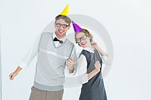 Geeky hipster couple wearing a party hat