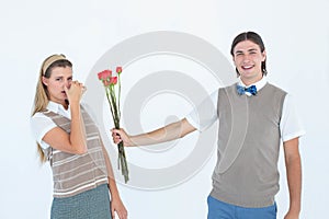 Geeky hipster offering red roses to his girlfriend