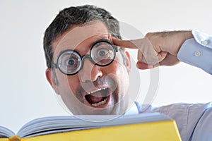 Geeky man thinks about an idea he read in a book photo