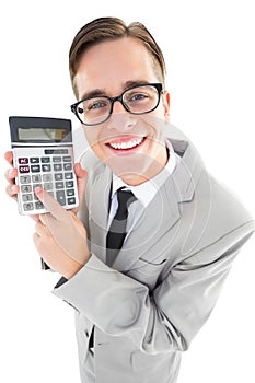 Geeky smiling businessman showing calculator