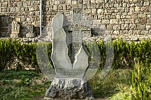 Khachkar from basalt carved as a donative to the monastery and installed in the Park near the stone wall, located around the monas