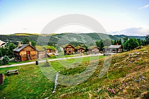 GEILO, NORWAY: Old traditional framehouses with grass on the roof in the middle of valley, Geilo, Norway