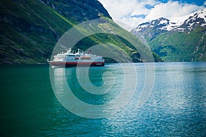 Geiranger fjord, Norway-JUNE 15,2012: the cruise ferry Hurtigruten sails along Geirangerfjord. The trip has been described as the