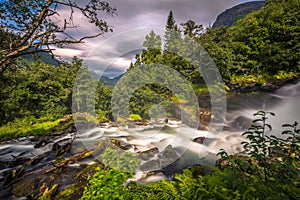 Geiranger - July 30, 2018: Waterfall in camping site in Geiranger, Norway