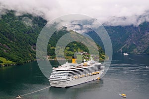 Geiranger, Norway - January 25, 2010: adventure, discovery, journey. Cruise ship in norwegian fjord. Passenger liner docked in por