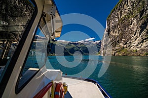 Geiranger, Norway - June, 2019: Hurtigruten cruise liner sailing on the Geirangerfjord, one of the most popular destination in