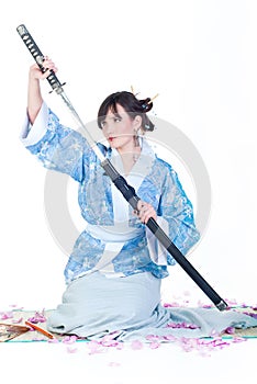 Geisha in blue kimono with katana photo