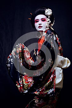 Geisha in kimono on black