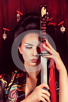 Geisha in kimono with samurai sword