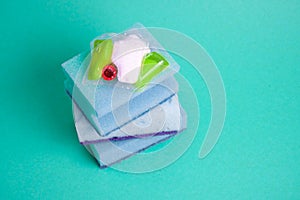 gel capsules for dishwashers sponges on a green and yellow background of the places of the copy top view, the choice between