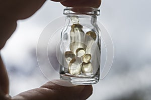 Gel capsules in a glass bottle