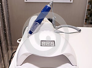 gel polish remover and manicure dryer on a table photo