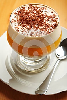 Gelatin dessert with chocolate and cream in glass