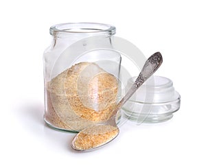 Gelatin or gelatine in the glass jar. On white background. photo